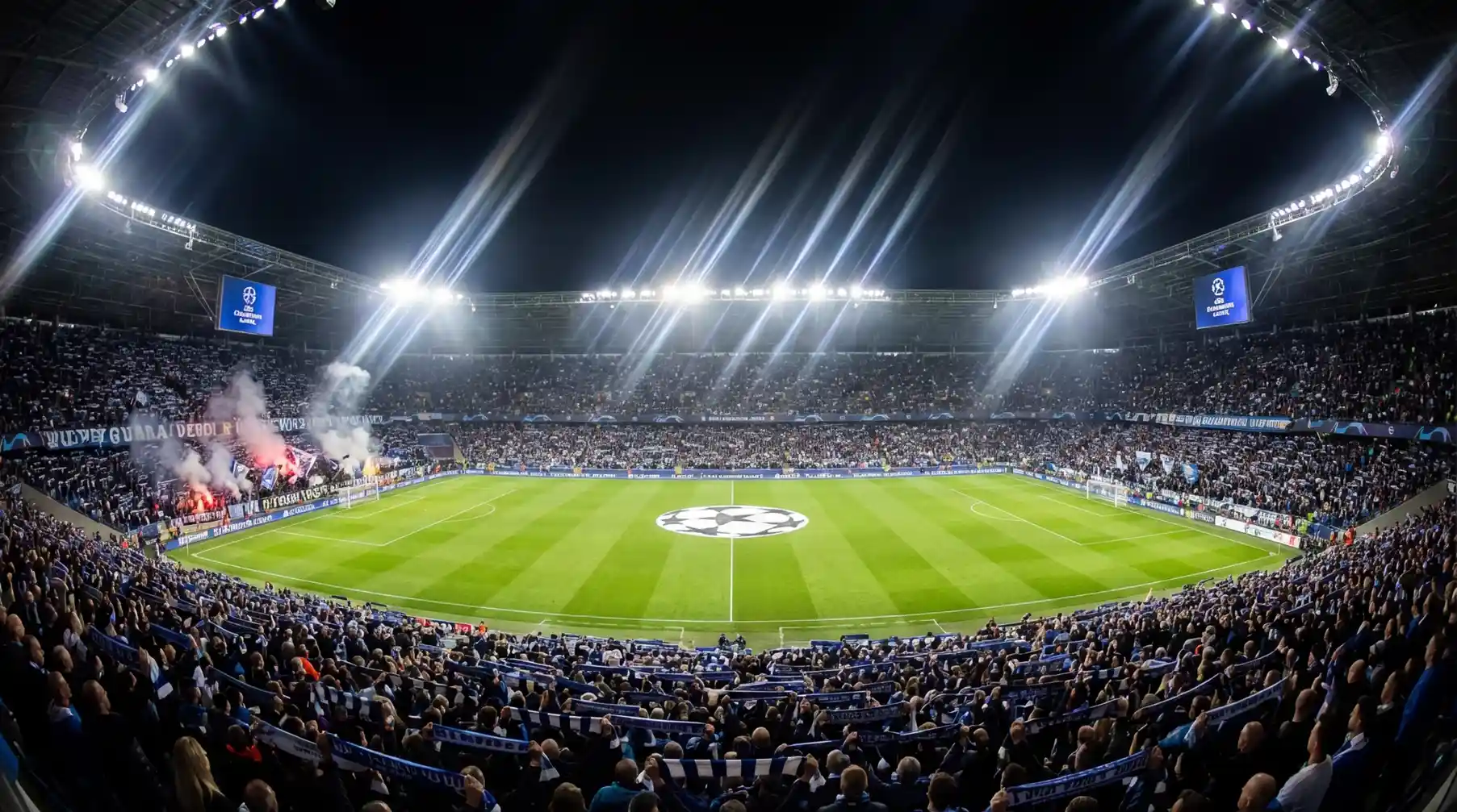 Estadio de fútbol iluminado durante partido nocturno de Champions League